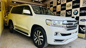 Toyota LandCruiser AX-G V8 4500cc
Model 2020 , fresh import March 2025
Mileage 29000 km , 
Auction grade 4.5 
Pearl White metallic with beige nappa leather interior ( new shade 2020 )
Brand new condition ( spotless)
Sunroof 
Leather multi power electric seats 
Electric Cool box 
8 zone climate control dual air conditioning 
Adapter cruise control 
Adapted Radar & line accessed 
Full wooden interior with ambient interior lighting 
Adaptive led all climate headlamps 
Tasla monitor installed  with android apps, Apple CarPlay & active navigation 
Full ZX customised fittings 
20” alloy wheels 
Full Crome package 
Full original factory fitted Modulista body kit 
Further information please call & visit at Victory Cars jail road Lahore.