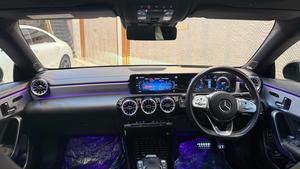 Mercedes-Benz CLA200  AMG -S ( twin turbocharged ) night black package 
Model 2021 registered 2022 in Islamabad 
Shahnawaz import.
Pearl black metallic with twin shadesd Dezine line AMG leather interior 
Mileage 24000 km
Bumper to Bumper original & spotless condition 
Top of line customised specs. 
Memory package, 14 electric power seats ejectment , heated & ventilated seats 
AMG spot bucket seat 
Multi zone climate control air conditioning 
Burmaster pro. surround sound entertainment system 
Panoramic electric sunroof 
Head up display 
Multi massager seats package 
Telescopic electric steering wheel 
Paddle shifter 
Adapted cruise controls 
Radar & adapted line accessed 
360 degrees cameras 
Multi zone auto parktronic package 
64 colours ambient lights interior 
Perfume package 
Multi driving modes eco, individual, sport, sport + & comfort.
Privacy glass package 
AMG sport suspension 
Wireless charger 
Wireless Apply CarPlay & android apps 
AMG muffler with change sound 
19 “ AMG sport alloy wheels 
Full AMG body kitted 
GT line front grill
Flat screen o led smart cluster 
Adapted led laser headlights 
Further information please call & visit at Victory Cars jail road Lahore.